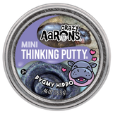 Round tin of dark glittery putty with purple label featuring a smiling cartoon hippo and hearts design