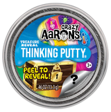 Round container of Crazy Aaron’s Treasure Reveal Thinking Putty with colorful label showing a locked treasure chest and peel-to-reveal feature