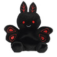 Small black plush toy with red eyes and embroidered red wing details smiling gently sitting upright