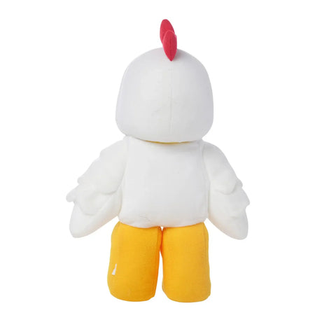 Plush soft toy shaped like a white chicken with red comb and bright yellow legs viewed from the back