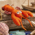 Louella Lobster Felt Ornament featuring an orange felt lobster with googly eyes and dangling claws