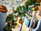 Decorative Christmas garland with handcrafted ornaments including Santa, reindeer, snowman, gift, and candy cane designs.