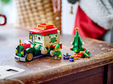 A festive toy truck with a Christmas tree, presents, and an elf minifigure ready for holiday play.