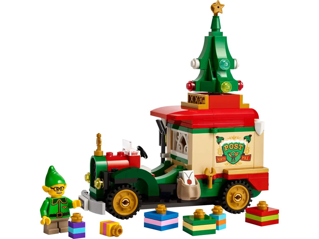 Colorful toy delivery truck with Christmas tree on top, mini elf figure, presents, and festive decorations for holiday play.