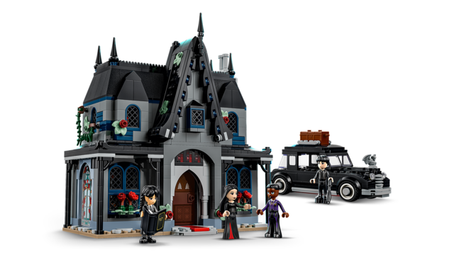 Six-room gothic cottage playset with opening sides, including four minidoll figures and a black vintage car with luggage.