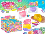 Sugar Swaps Cheese Wedge colorful cheese-shaped squishy toy shown in packaging and stacked with vibrant pieces