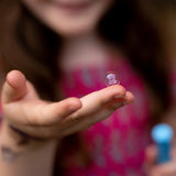 Bubbles of Steel: Touchable Bubbles showing a child holding a bubble on an open hand