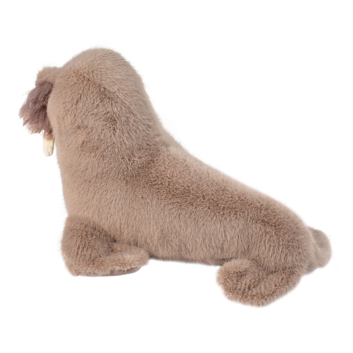 Soft plush walrus with light brown fur, white tusks, and whiskers lying on white background