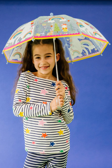 Girl holding Color-Change Umbrella | Transparent Rainbow Fairy with rainbows and fairies on a blue background
