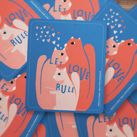 Let Love Rule Vinyl Sticker with pink and orange cats and heart shapes, waterproof and sun-proof, made in USA.