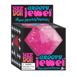 Bright pink glittery squishy jewel toy in black packaging labeled Nee Doh Groovy Jewel for kids ages three and up