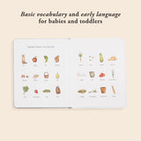 Open children’s book with watercolor illustrations of farm animals, fruits, vegetables, and simple vocabulary words