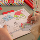 My Christmas Coloring Book & Stickers! with a child coloring a festive Santa illustration