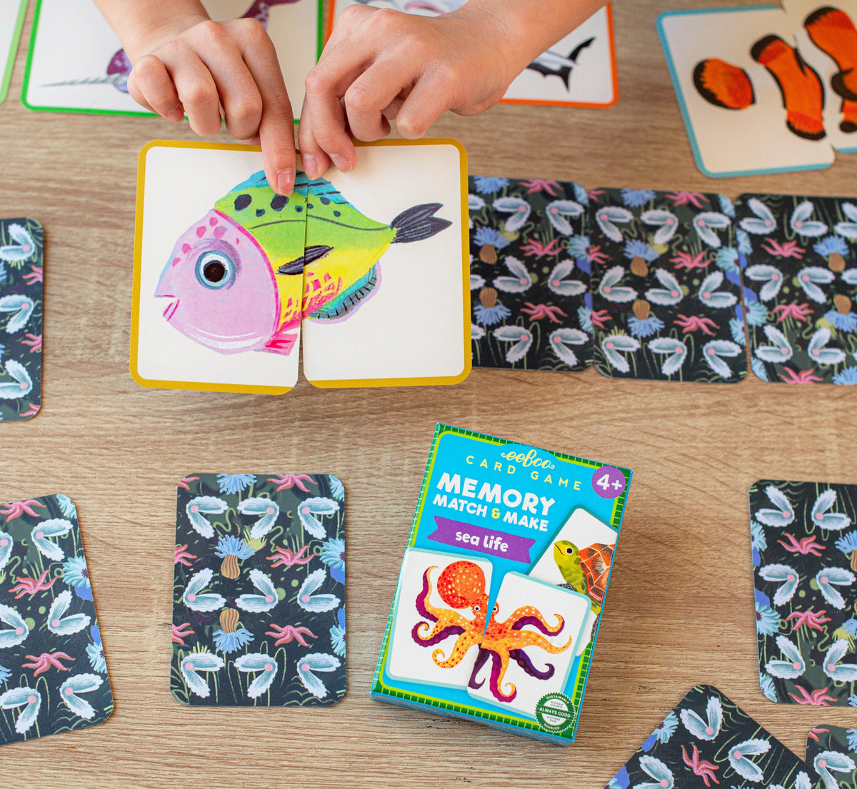 Sea Life Memory Match & Make Game with colorful sea creature cards and children playing