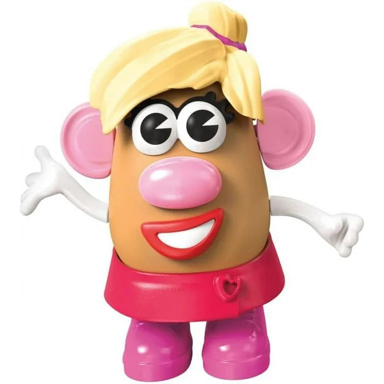 Toy figure with tan body, large pink ears, pink nose, red lips, white arms, pink shoes, and blonde hair tied with purple band