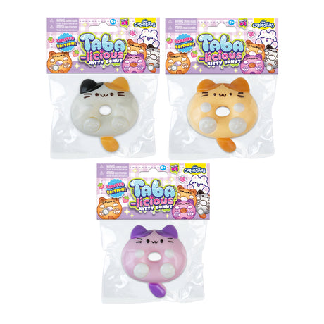 Three Taba-licious Kitty Donuts, soft squishy toys shaped like cats with donut holes, in various colors and packaging