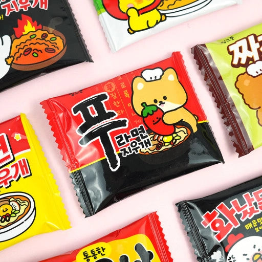 Colorful packaging of a ramen-shaped eraser with cute cartoon designs on a light pink background