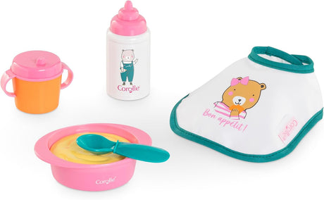 Toy feeding set with pink bowl, teal spoon, orange sippy cup, white bottle, and bib with bear illustration