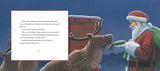 Santa handing a green gift to a brown reindeer standing in front of a chimney against a dark blue sky