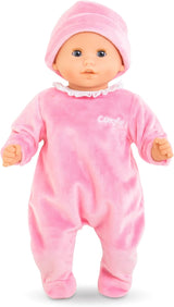 Baby doll wearing soft pink sleeper with white ruffled collar and matching pink hat on a white background