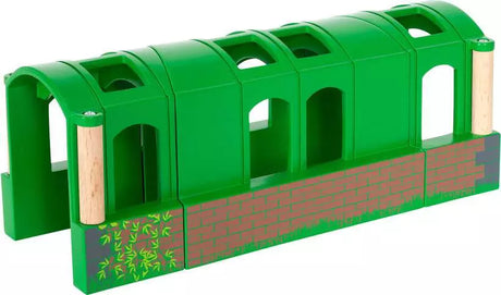 Flexible Tunnel toy in green with four connected arched tunnel pieces made from wood and plastic for BRIO railway play.
