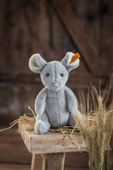 Mouse Cheesy soft grey plush mouse from Soft Cuddly Friends collection sitting on rustic wooden bench.