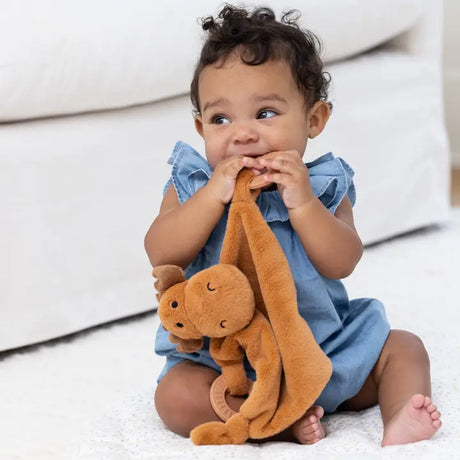 Baby playing with Teether Buddy | Max the Moose, a plush teething toy with soft silicone rings and gentle rattle.