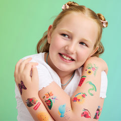 Temporary Tattoo Single featuring a smiling child with colorful temporary tattoos on her arms
