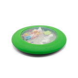 Green circular sensory toy with clear center containing miniature farm animals and small white beads inside