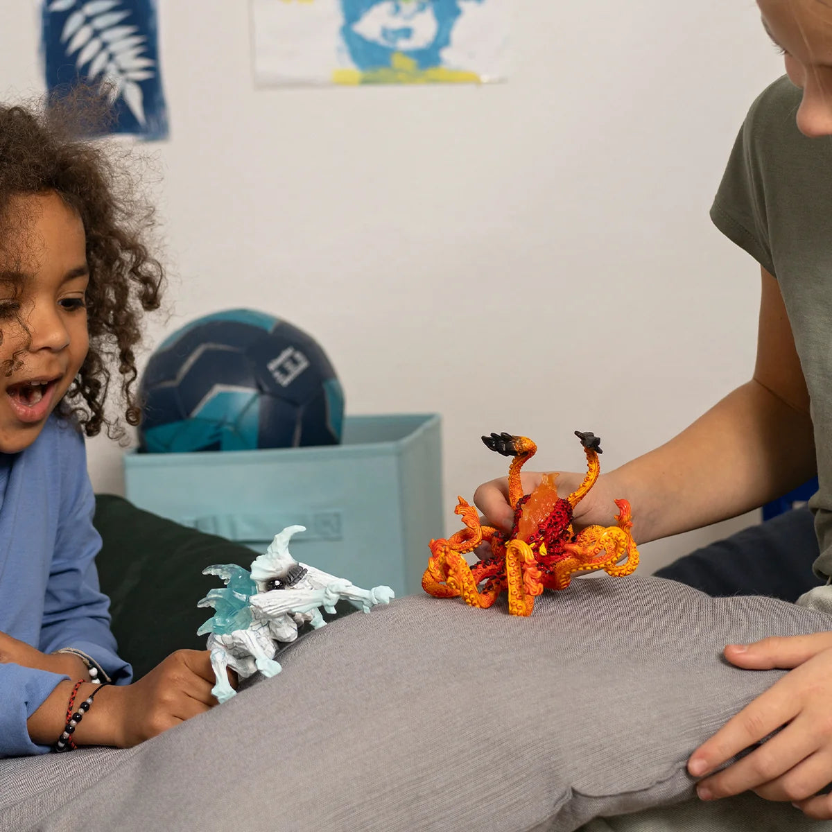 Eldrador | Ice Bug vs Fire Kraken toy figures battling on a cushion