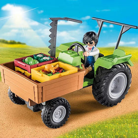 Country | Harvester Tractor w/Trailer with toy farmer transporting fresh vegetables in crates on a sunny farm path.
