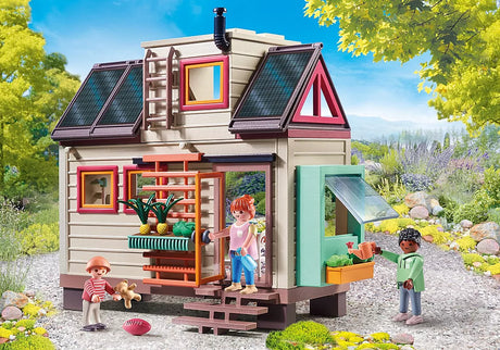 My Life | Tiny House with solar panels, vertical garden, three figures playing outside the two-story sustainable play home.