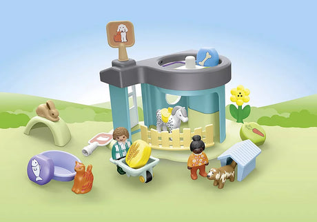 Junior | Animal Home with Treat Dispenser playset featuring animals, children, and interactive feeder in a colorful outdoor scene.