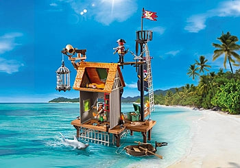 Pirates | Pirate Harbor toy set on beach with pirate figures, lookout tower, cage, and small boat by the sea.