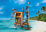 Pirates | Pirate Harbor toy set on beach with pirate figures, lookout tower, cage, and small boat by the sea.