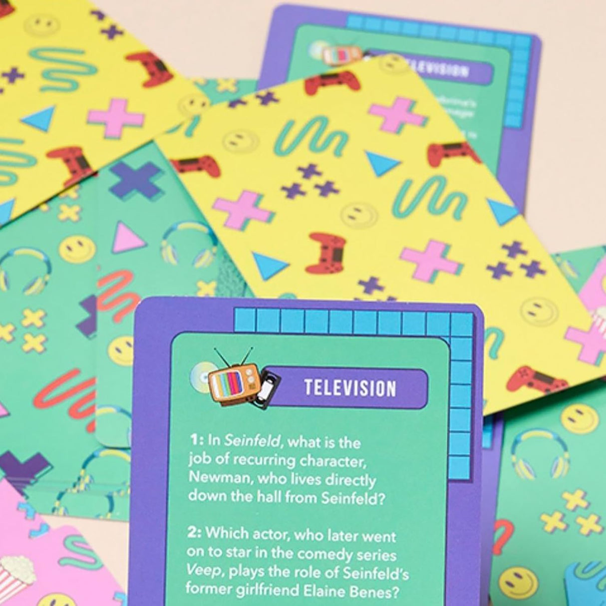 Colorful trivia cards with 90s themed questions about TV shows like Seinfeld on a pastel background