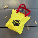 Catan Zip! yellow tote bag with red handles and graphic logo