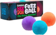 Three colorful teenie fuzz balls with soft textured spikes next to black packaging with bright text and designs