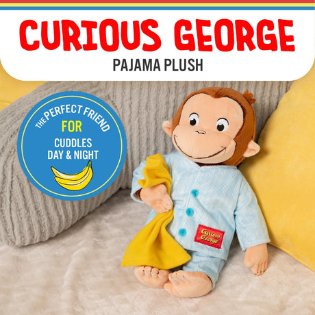 Curious George Pajamas plush holding a yellow blanket, wearing soft blue pajamas with buttons, sitting on a bed.
