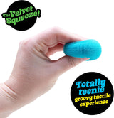 Hand holding a small blue NeeDoh Teenie Fuzz Ball with soft, fuzzy texture for a relaxing tactile experience