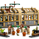 Harry Potter Hogwarts Castle: Herbology Class LEGO set with greenhouse, Mandrake plants, and minifigures gardening.