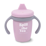 Pink toddler sippy cup with gray handles and lid featuring the phrase "Spill the Tea" in white letters
