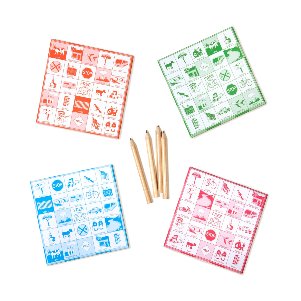 Travel Bingo game cards in red green and blue with four wooden pencils