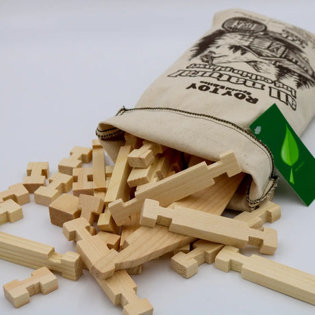 Log Cabin Natural Playset Bag with natural wood pieces spilling from a 100% cotton duck bag for creative building.