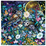 Intricate puzzle showing two owls surrounded by colorful flowers, butterflies, and a glowing golden moon at night