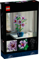 LEGO Botanicals Hibiscus with five large purple flowers and dark blue pot displayed on a windowsill