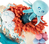 Sensorial Reef toy featuring a baby octopus rattle with squeezable coral textures for sensory play and exploration.