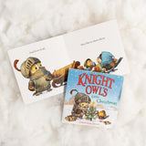 Open children's book Knight Owl's Little Christmas showing owl in armor and festive winter scene with friends sharing gifts
