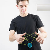 Young man performing advanced string trick with blue metallic yo-yo against plain white background
