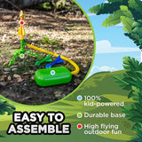 Stomp Rocket DinoSoar launch stand with colorful rockets set up outdoors on the ground ready for play